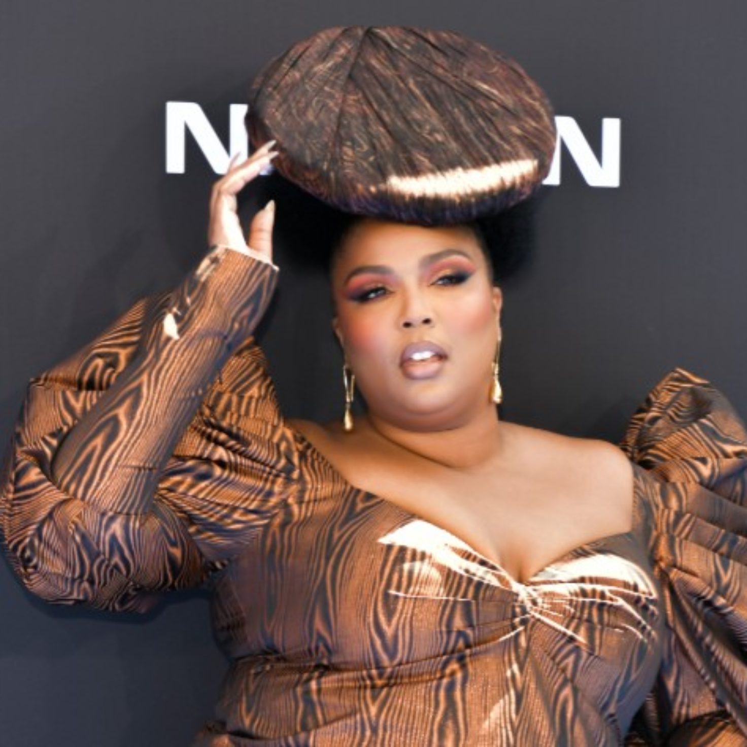 Lizzo Opted For Wood Grain And Natural Hair For Her BET Awards Look