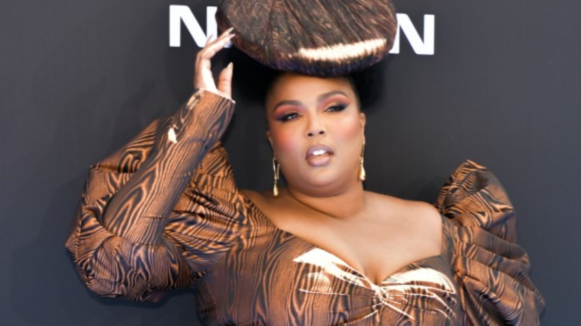 Lizzo Opted For Wood Grain And Natural Hair For Her BET Awards Look