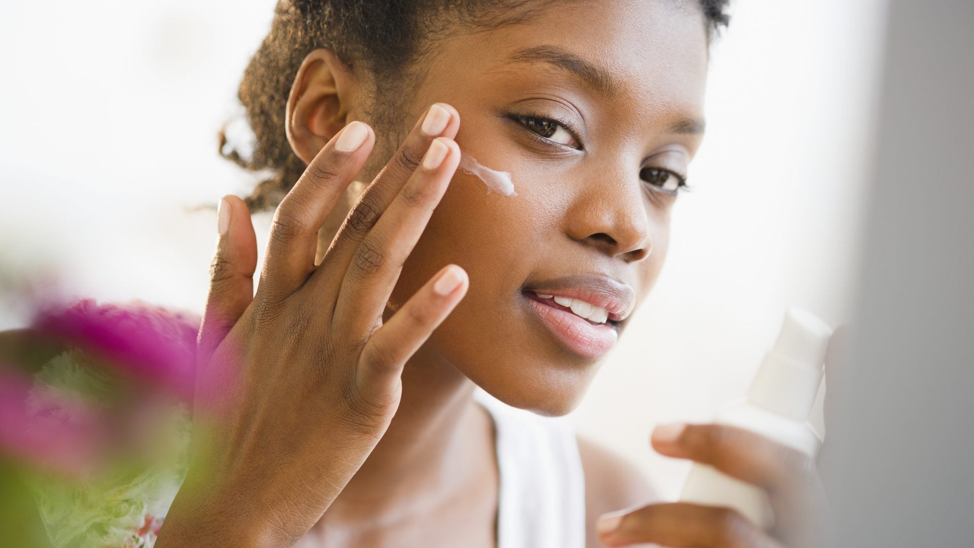 Black Woman Applying skincare